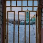 a view of a building through a gate