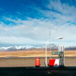 empty gas station near empty road facing snow capped mountain at daytime